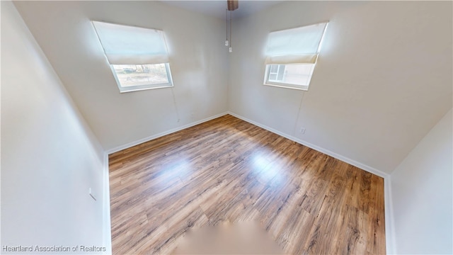 empty room with wood finished floors and baseboards