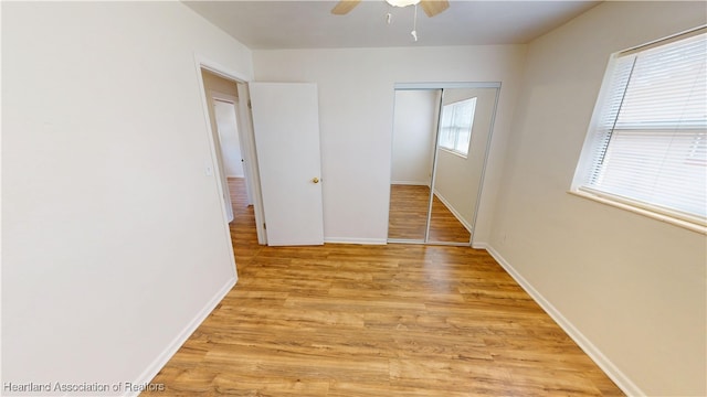 corridor with baseboards and light wood-style flooring