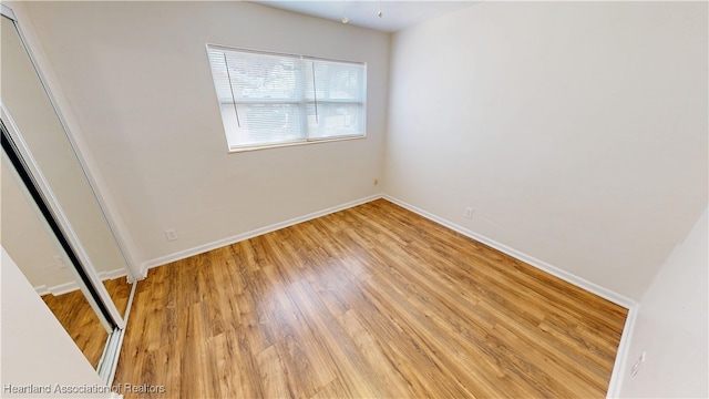 unfurnished bedroom featuring baseboards and light wood-style floors