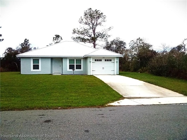 view of front of property featuring a garage, a front yard, concrete driveway, and stucco siding