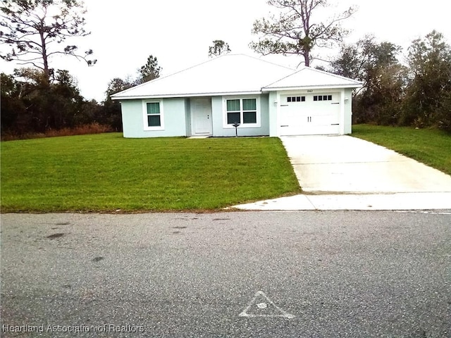 view of front of property with stucco siding, an attached garage, concrete driveway, and a front lawn