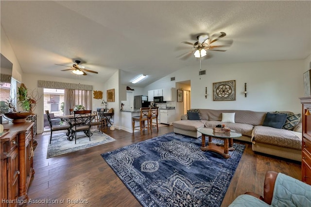 4212 Elson Ave, Sebring, FL 33875 - living area featuring ceiling fan, vaulted ceiling, and dark wood-style flooring