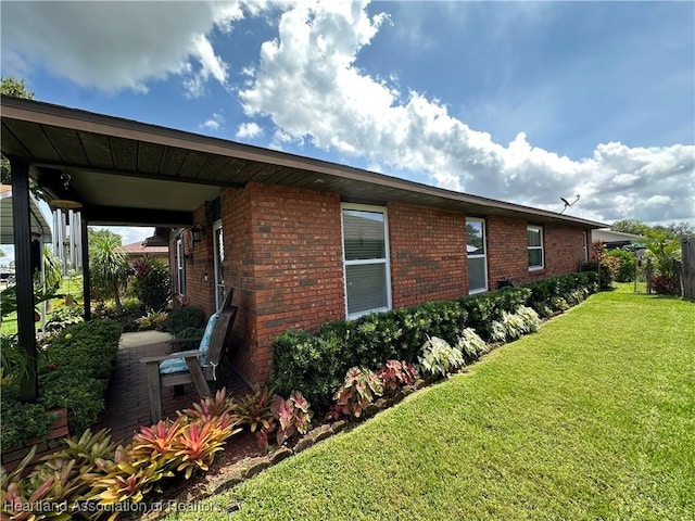 4212 Elson Ave, Sebring, FL 33875 - view of side of property with a yard and brick siding