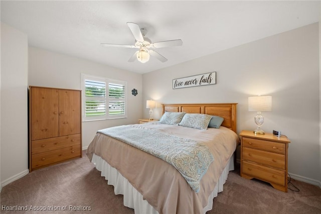carpeted bedroom with ceiling fan and baseboards