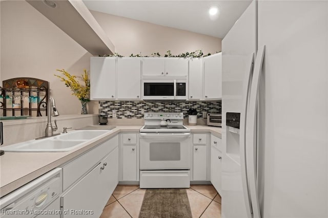kitchen featuring decorative backsplash, a sink, white appliances, and light tile patterned floors