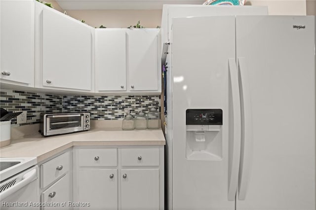 kitchen with tasteful backsplash, light countertops, white cabinetry, and white fridge with ice dispenser