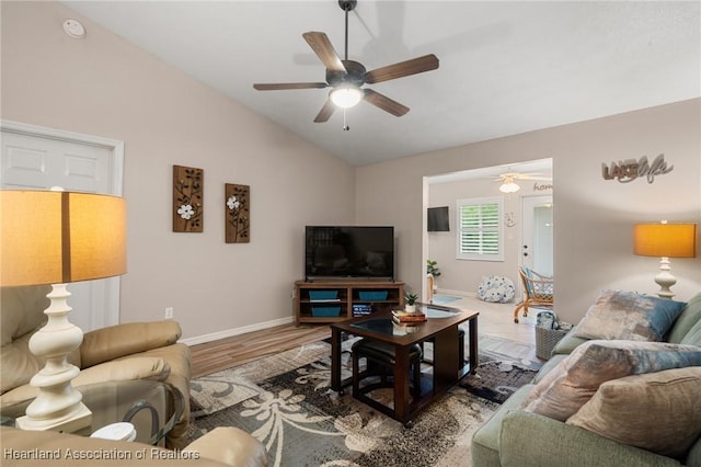 living room with wood finished floors, baseboards, a ceiling fan, and lofted ceiling