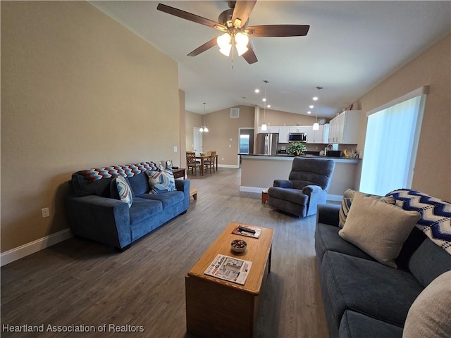 living room with hardwood / wood-style flooring, ceiling fan, and vaulted ceiling