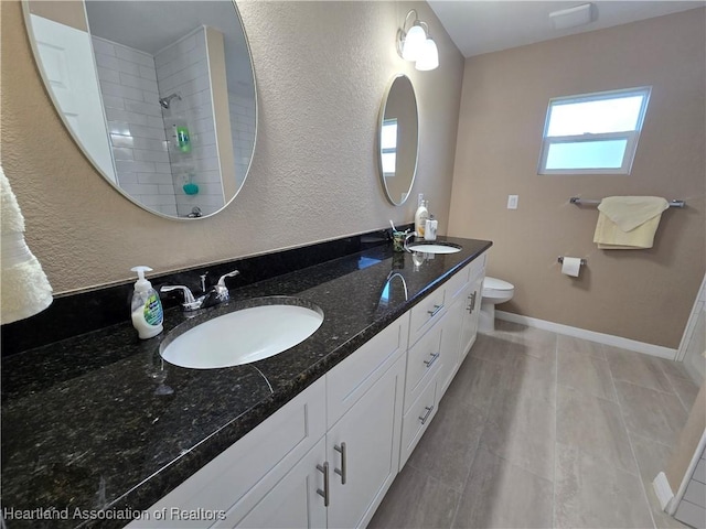 bathroom featuring walk in shower, vanity, and toilet