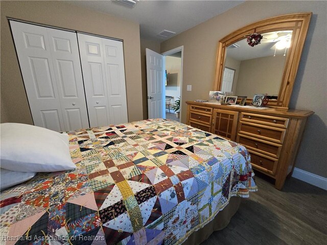 bedroom with ceiling fan, dark hardwood / wood-style flooring, and a closet