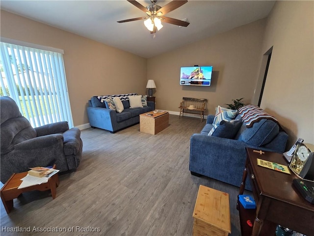 living room with hardwood / wood-style flooring, vaulted ceiling, and ceiling fan