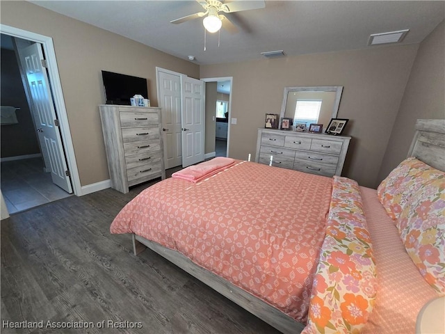 bedroom with dark hardwood / wood-style flooring and ceiling fan