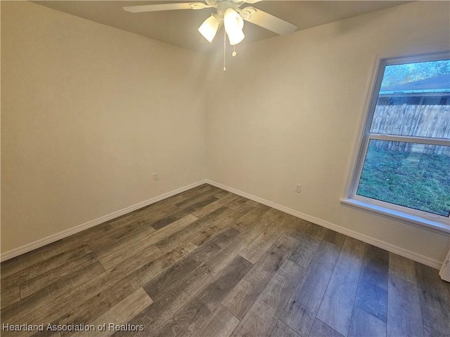 1703 N Morningside Rd, Avon Park, FL 33825 - spare room with a ceiling fan, dark wood-style flooring, and baseboards