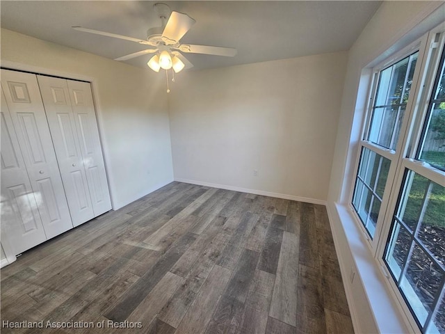 1703 N Morningside Rd, Avon Park, FL 33825 - unfurnished bedroom with a closet, multiple windows, ceiling fan, and wood finished floors