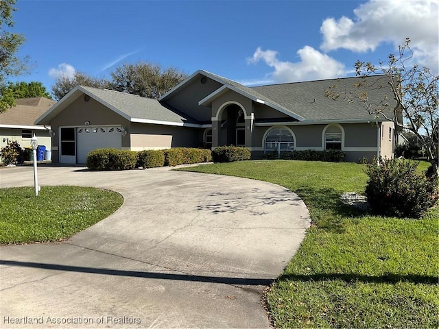 ranch-style house with a front yard, driveway, an attached garage, and stucco siding