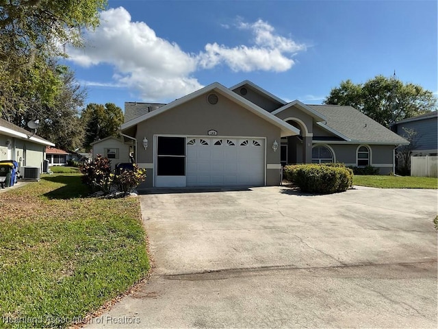 view of front of home featuring central air condition unit, stucco siding, an attached garage, a front yard, and driveway