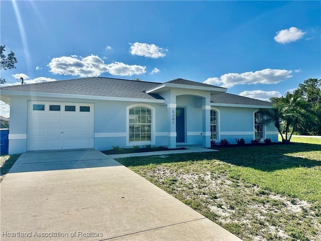 ranch-style house with an attached garage, a shingled roof, stucco siding, a front lawn, and concrete driveway