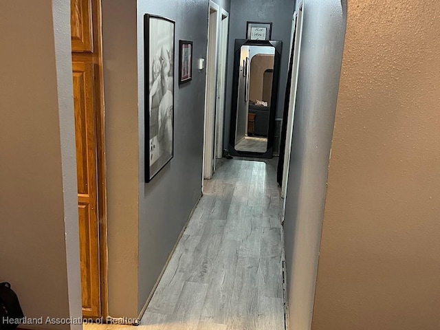 315 Indiana Ave, Wauchula, FL 33873 - hallway featuring a textured wall and light wood-type flooring