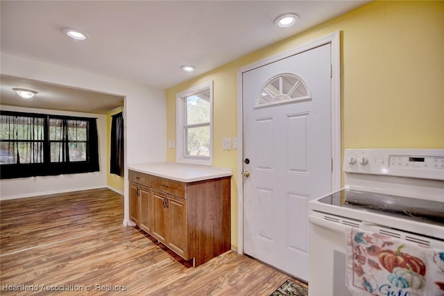 kitchen with white range with electric cooktop and light wood-type flooring