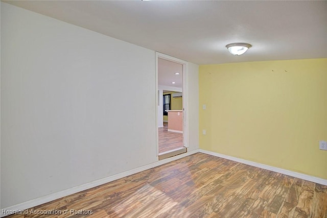 unfurnished room with hardwood / wood-style flooring