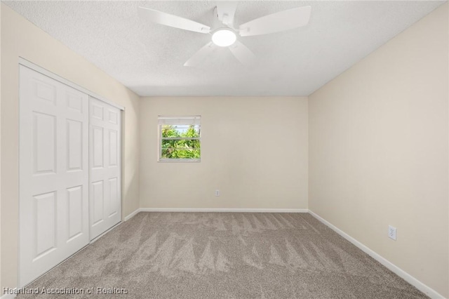 4304 Lewis Ave, Sebring, FL 33875 - unfurnished bedroom featuring carpet, a closet, a ceiling fan, and a textured ceiling