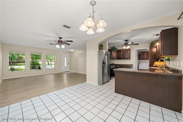 4304 Lewis Ave, Sebring, FL 33875 - kitchen featuring stainless steel fridge with ice dispenser, ceiling fan, arched walkways, open floor plan, and a peninsula