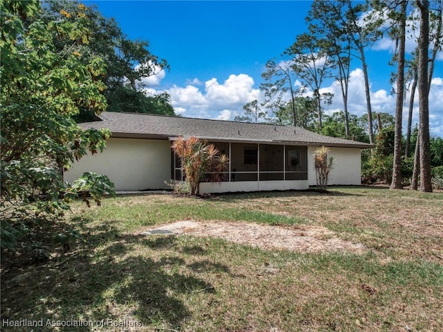 4304 Lewis Ave, Sebring, FL 33875 - back of property featuring a sunroom, a yard, and stucco siding