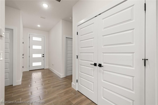 5243 Cortez Blvd, Sebring, FL 33872 - foyer entrance featuring baseboards, light wood-style flooring, and recessed lighting