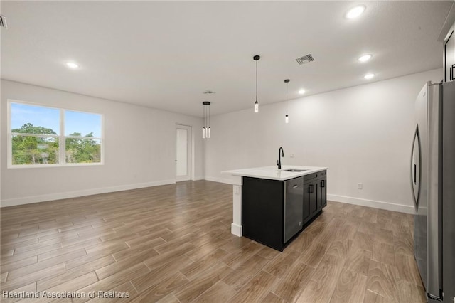 5243 Cortez Blvd, Sebring, FL 33872 - kitchen with appliances with stainless steel finishes, light countertops, light wood-style flooring, a sink, and dark cabinets