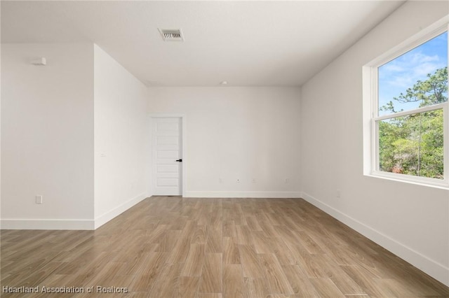 5243 Cortez Blvd, Sebring, FL 33872 - empty room with light wood-style flooring, healthy amount of natural light, and baseboards