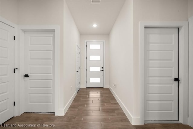 5243 Cortez Blvd, Sebring, FL 33872 - doorway featuring baseboards, dark wood-style floors, and recessed lighting