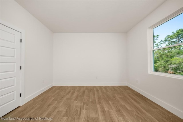 5243 Cortez Blvd, Sebring, FL 33872 - empty room featuring healthy amount of natural light, light wood-type flooring, and baseboards
