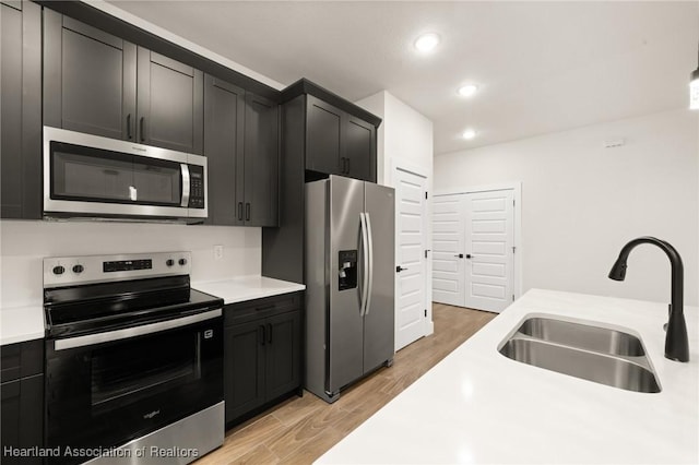 5243 Cortez Blvd, Sebring, FL 33872 - kitchen featuring stainless steel appliances, a sink, light countertops, light wood-style floors, and recessed lighting