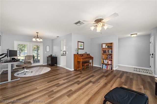 office space featuring wood-type flooring, ceiling fan with notable chandelier, and french doors