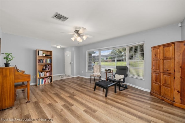 sitting room featuring ceiling fan and light wood-type flooring