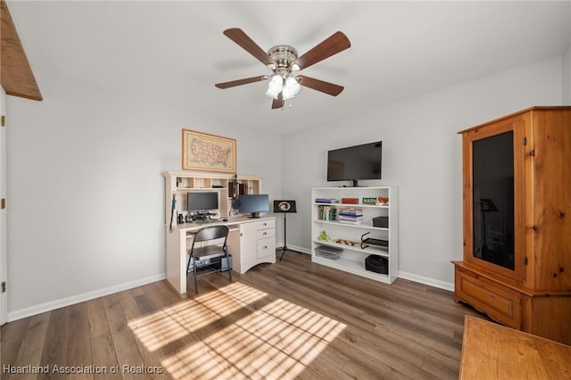 office area with ceiling fan and dark hardwood / wood-style floors