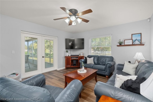 living room with hardwood / wood-style flooring, ceiling fan, a wealth of natural light, and french doors