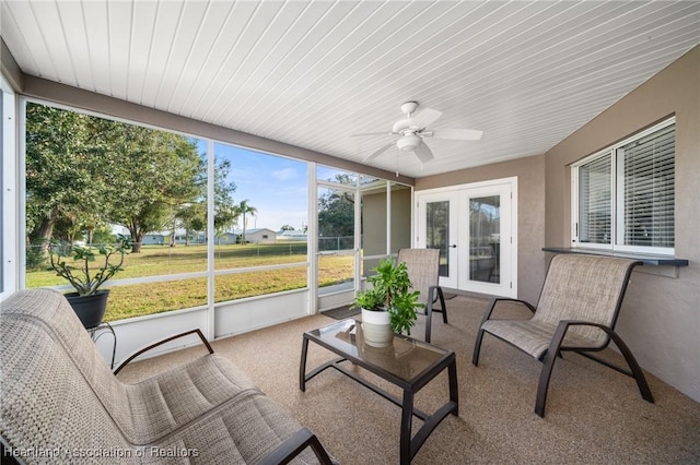 sunroom featuring ceiling fan and french doors