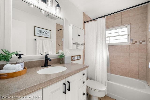 full bathroom with vanity, toilet, and shower / bath combo with shower curtain