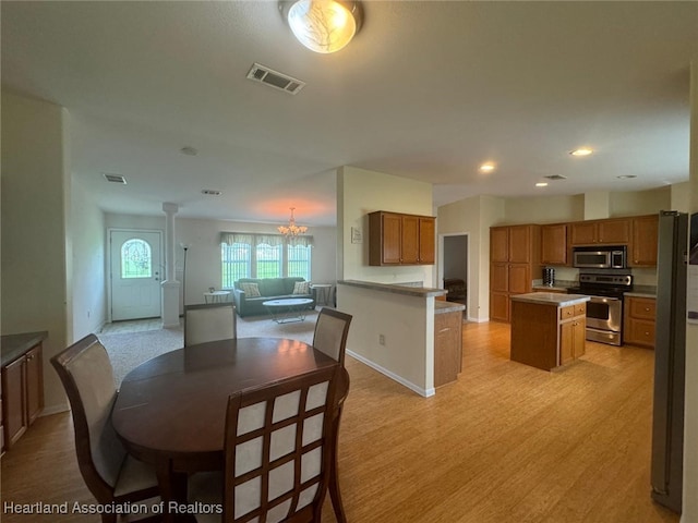 dining area featuring a chandelier and light hardwood / wood-style flooring