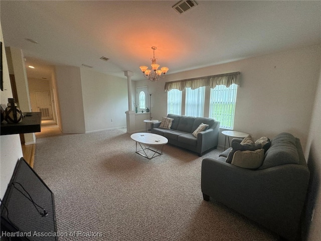 living room with carpet and an inviting chandelier