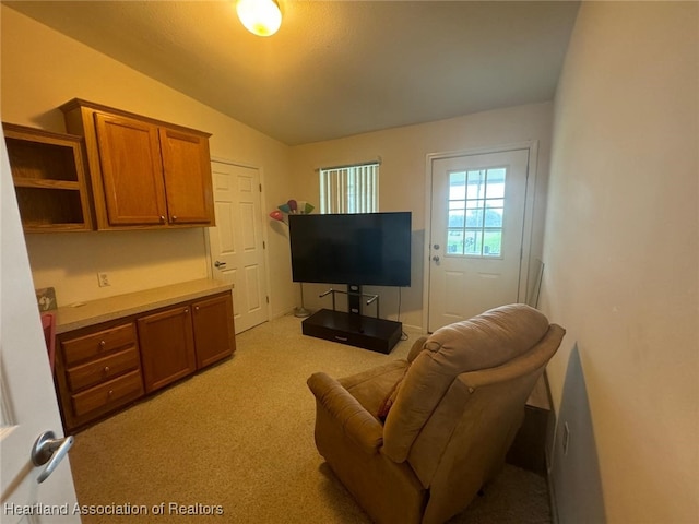 carpeted living room with vaulted ceiling