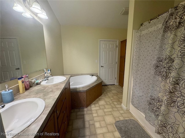 bathroom with a tub and vanity