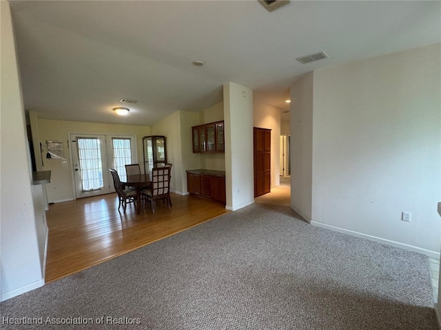 unfurnished dining area with dark colored carpet