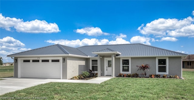 view of front of home with a front lawn and a garage