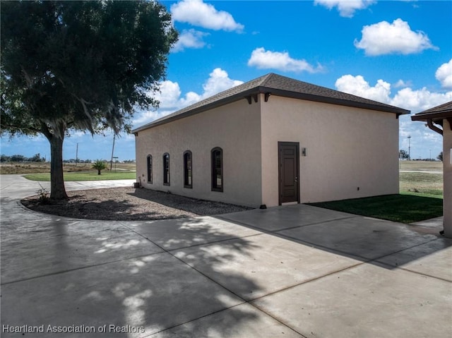 500 Heartland Blvd, Lake Placid, FL 33852 - view of home's exterior featuring stucco siding and a patio area