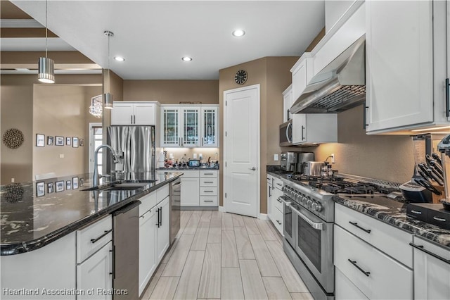 500 Heartland Blvd, Lake Placid, FL 33852 - kitchen with appliances with stainless steel finishes, extractor fan, a sink, white cabinetry, and recessed lighting