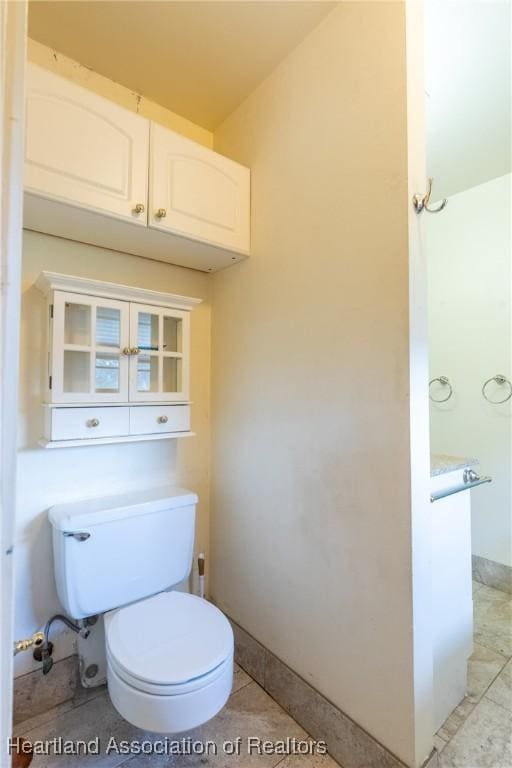 bathroom with tile patterned floors and toilet