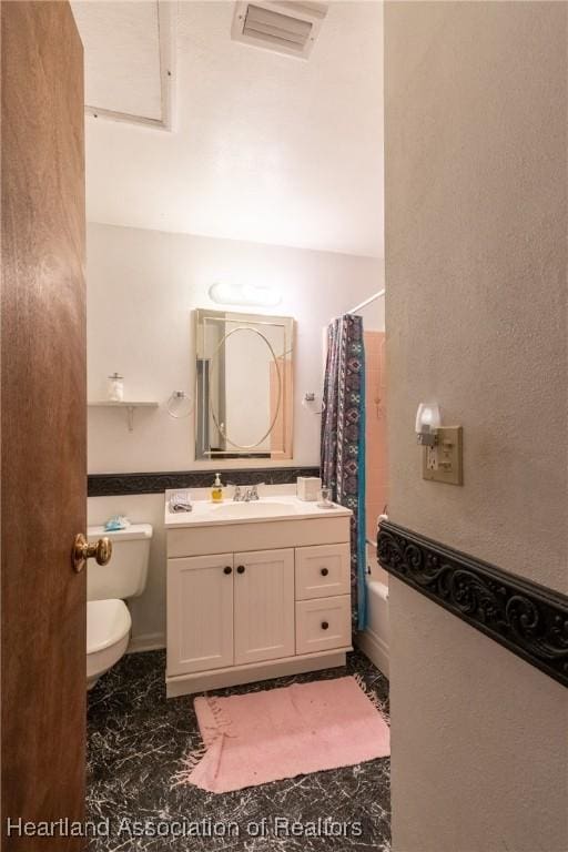 full bathroom featuring toilet, vanity, and shower / bathtub combination with curtain