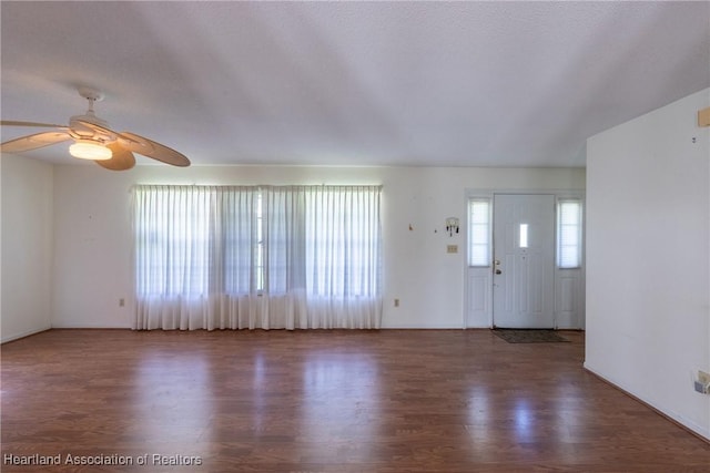 entryway with dark wood-type flooring and ceiling fan